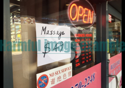 A massage business window shows an open sign, business hours, massage sign and $49 price and a sign that reads "no sex service." White SWAN logo with text reads: example harmful image.